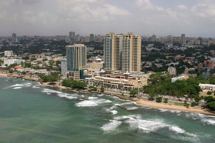 Aerial view of El Malecón and the obelisk along Santo Domingo's coastline at sunset